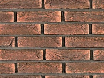 Textura zdi s klinkerovými cihlovými obklady v teplých hnědých tónech.