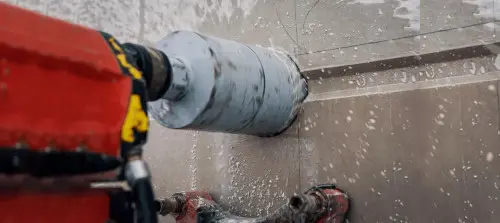 Jádrovým vrtákem se vrta do betonu s vodou.