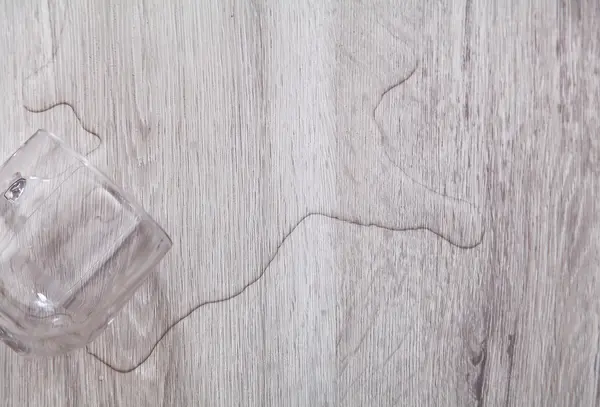 Voda z sklenice na vinylové podlaze - riziko vlhkosti.