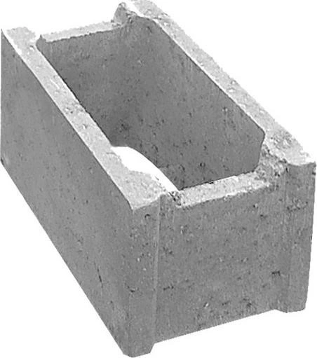 Šedý betonový blok s dutinou pro použití jako bednění ve stavbě.