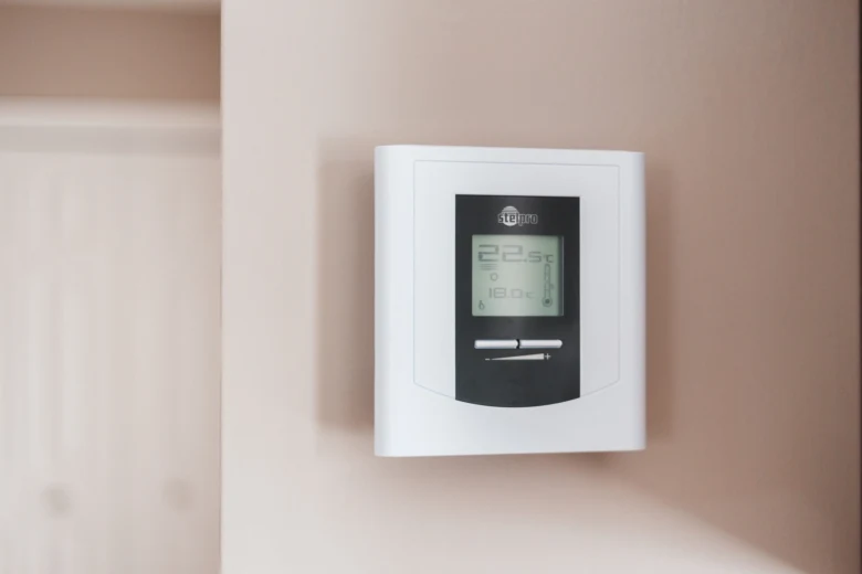 Digital thermostat on wall