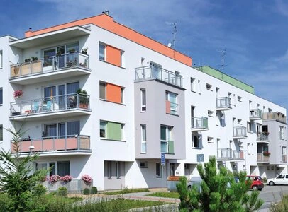 White apartment building with red roof