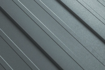 Detail plechové střešní krytiny s vlnitým profilem.