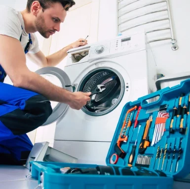 Technician repairing washing machine